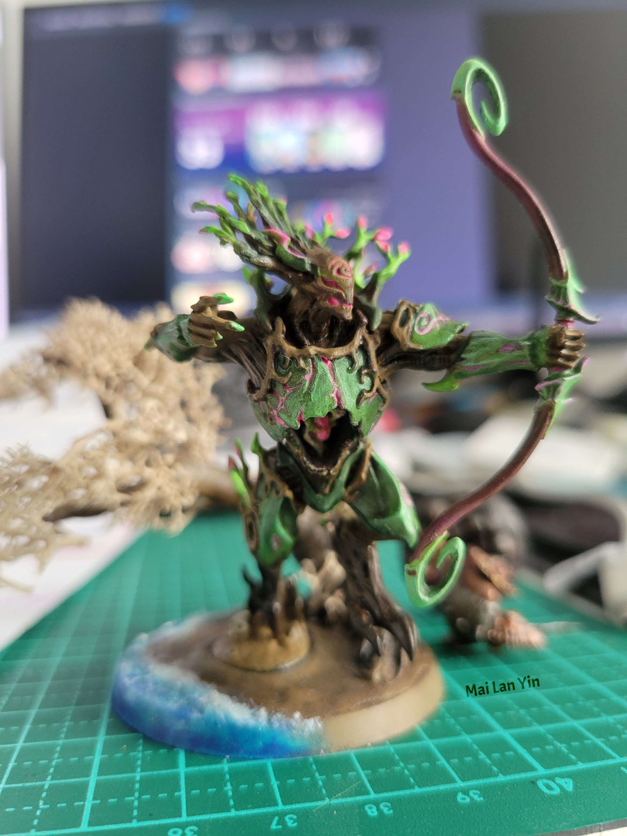 Photo of a painted Warhammer Sylvaneth figurine with a drawn bow